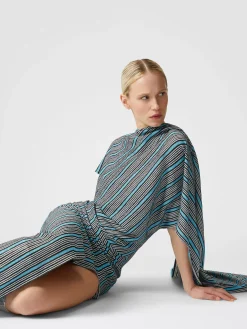 Peplum-cut dress in lamé viscose with side slit