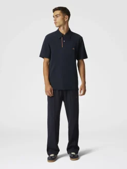 Solid color cotton piqué polo shirt with zigzag embroidery and contrasting detail