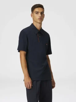Solid color cotton piqué polo shirt with zigzag embroidery and contrasting detail